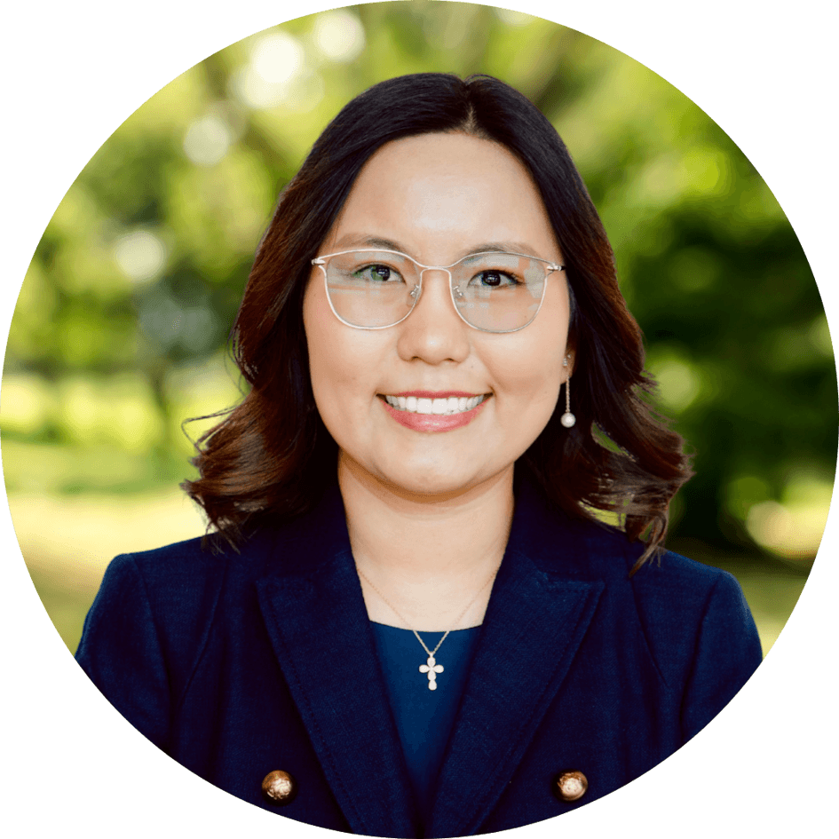 Counselor Alice Sainjargal smiles kindly in front of a nature background