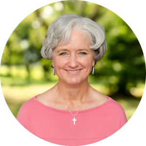 Headshot of Christian Counselor Cathleen Olney with Cornerstone Christian Counseling in front of a nature background