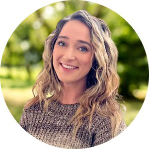 Erin Coughlin headshot in front of green nature background