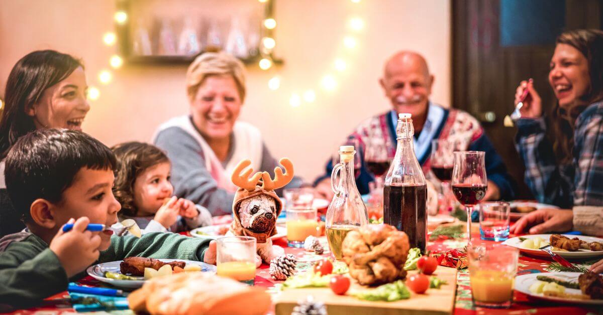 Big multi-generation family eating together at a warm Christmas dinner party