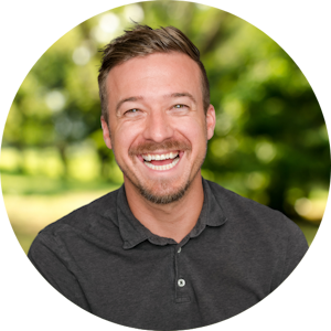 Counselor Kegan Mosier smiles brightly front of a nature background