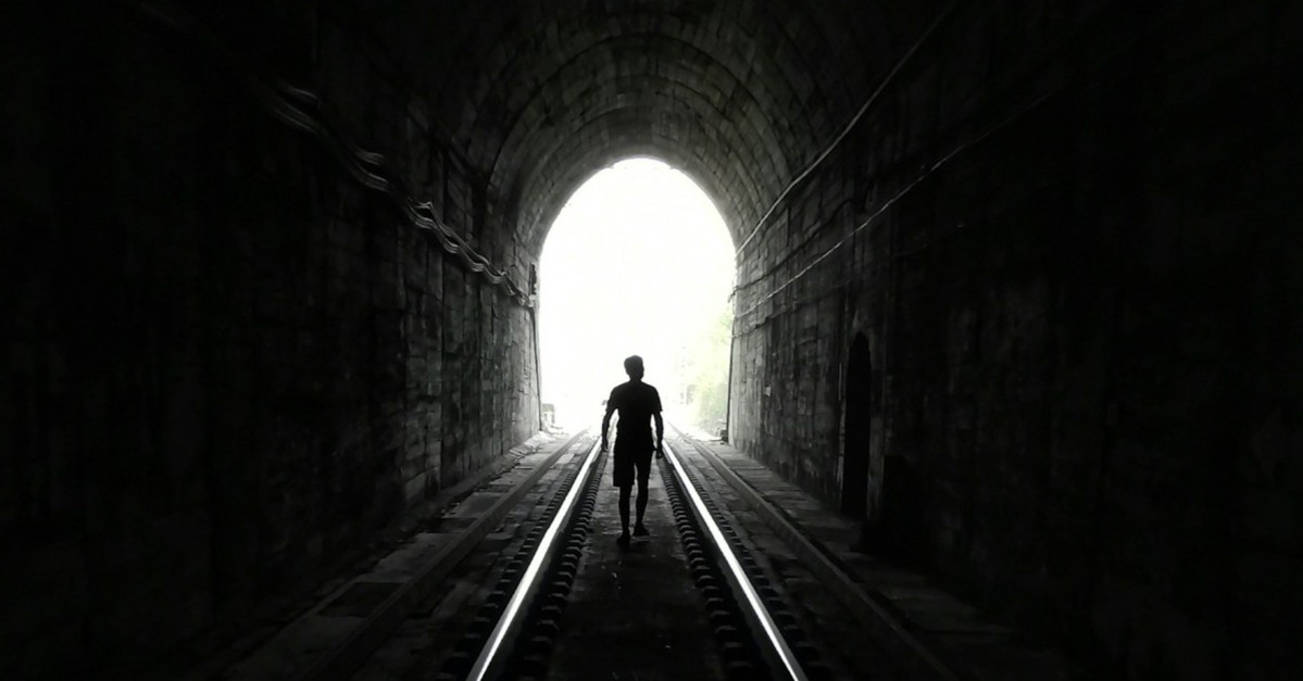 Man in a tunnel finding his way out