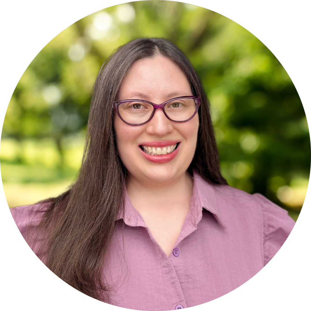 Smiling female counselor in glasses and pink shirt