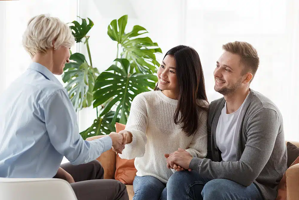couple-shaking-hands-with-counselor